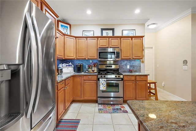 kitchen featuring tasteful backsplash, light stone counters, ornamental molding, stainless steel appliances, and light tile patterned flooring