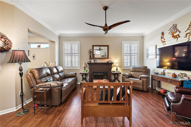 living room with dark hardwood / wood-style floors, ceiling fan, and crown molding