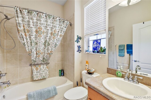 full bathroom featuring vanity, shower / bath combo, and toilet