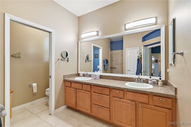 bathroom featuring tile patterned floors, vanity, and toilet