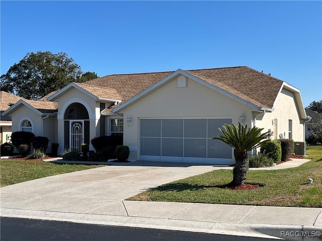 single story home featuring central air condition unit, a front lawn, and a garage