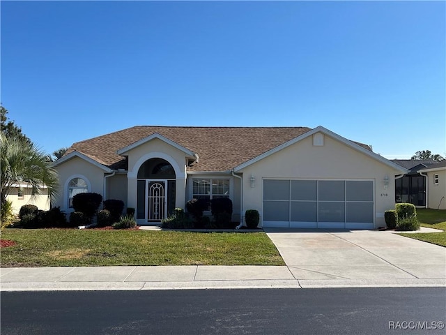 ranch-style house featuring a front lawn and a garage