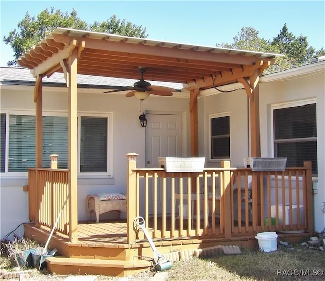 property entrance with ceiling fan and a deck