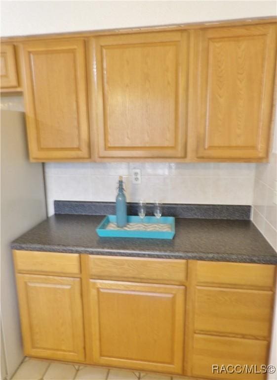 kitchen featuring light tile patterned floors and decorative backsplash