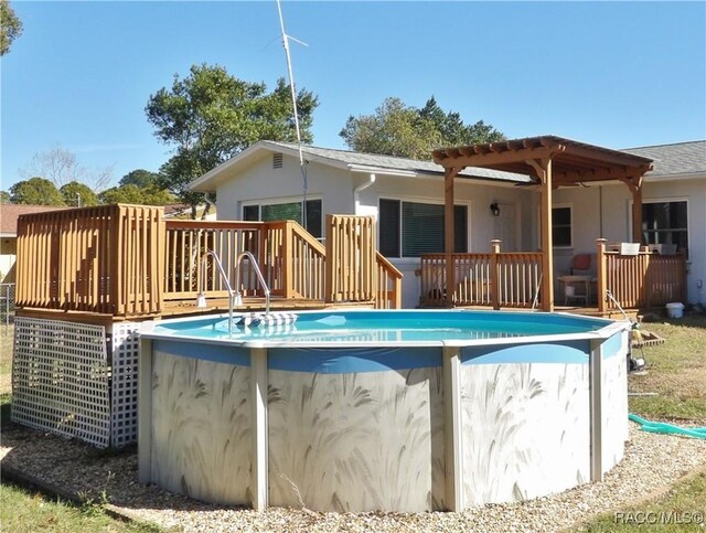 view of swimming pool with a wooden deck