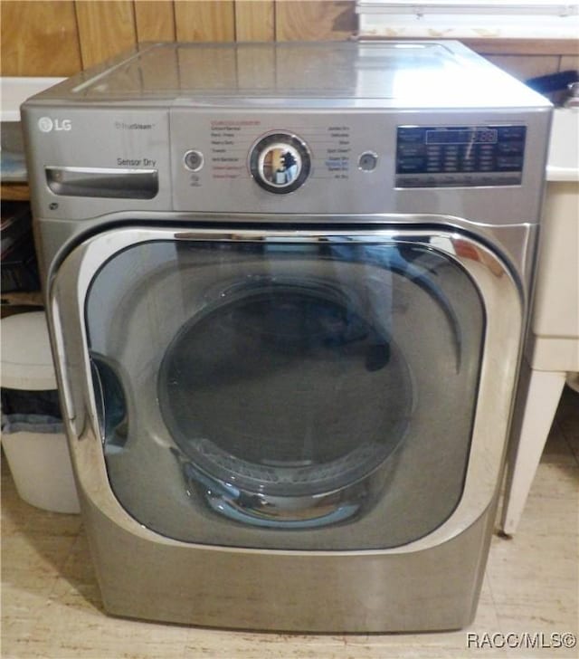 laundry room with light tile patterned flooring and washer / dryer