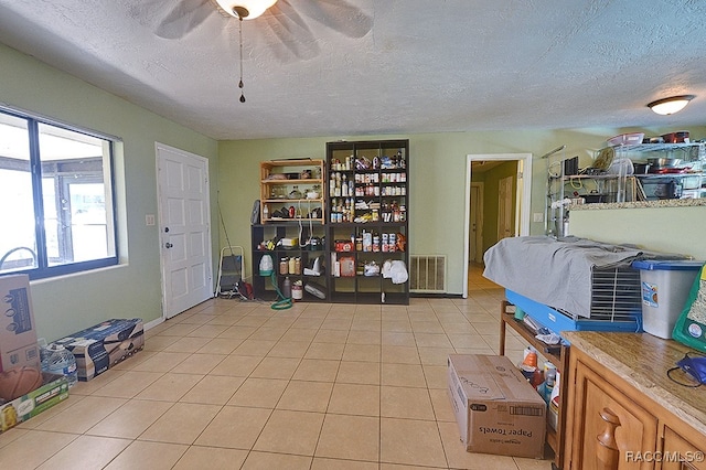 interior space featuring a textured ceiling and ceiling fan