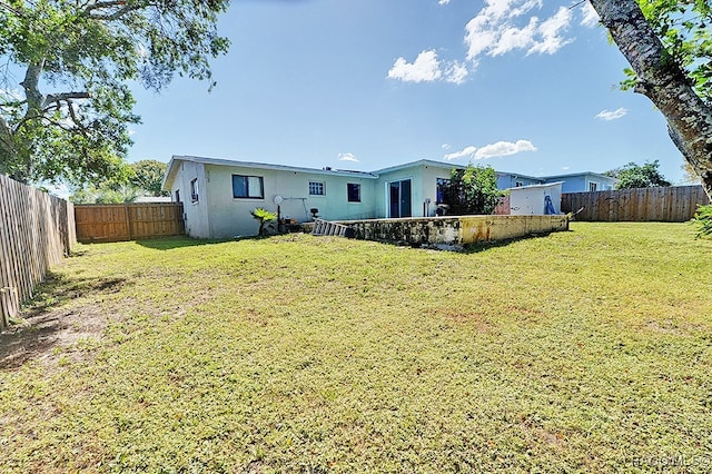 back of property with a lawn