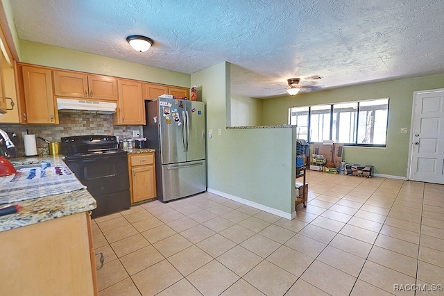 kitchen featuring black range with electric stovetop, sink, backsplash, stainless steel fridge, and light tile patterned floors