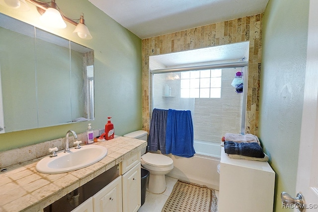 full bathroom featuring tile patterned flooring, vanity, enclosed tub / shower combo, and toilet