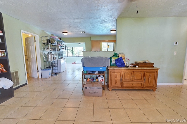 kitchen with light tile patterned floors and a textured ceiling