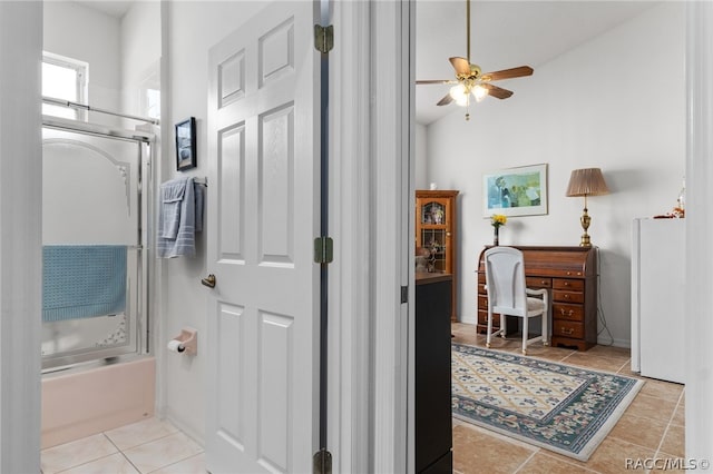 bathroom featuring tile patterned flooring, vaulted ceiling, bathing tub / shower combination, and ceiling fan