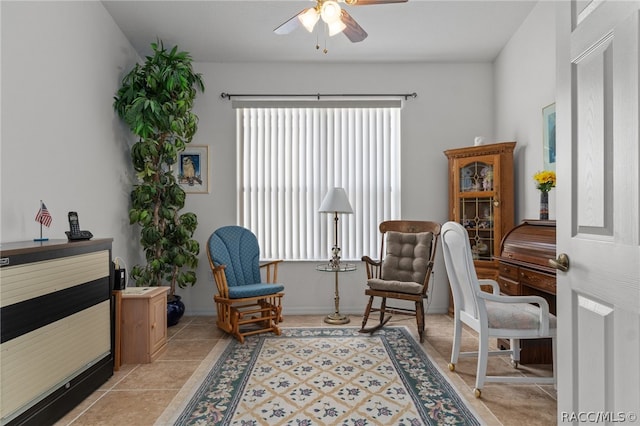 sitting room with ceiling fan and light tile patterned floors