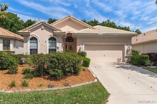 mediterranean / spanish-style home featuring a garage