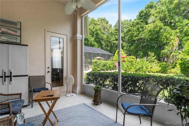 sunroom with ceiling fan and a healthy amount of sunlight