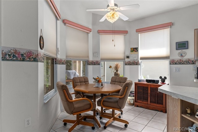 tiled dining area with ceiling fan