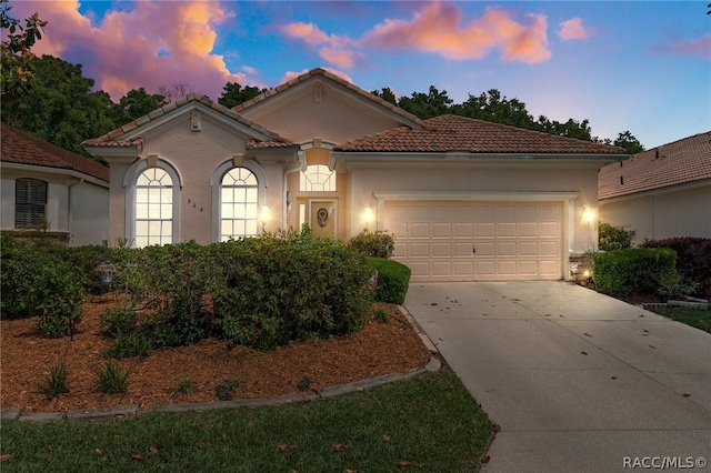 mediterranean / spanish-style house featuring a garage