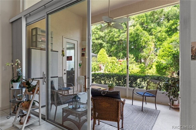 sunroom / solarium with ceiling fan and french doors