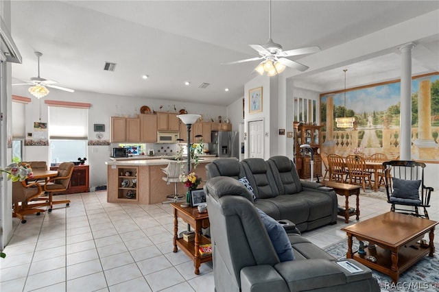 living room with light tile patterned floors, plenty of natural light, lofted ceiling, and ceiling fan