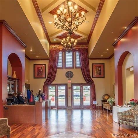 reception area with french doors and an inviting chandelier