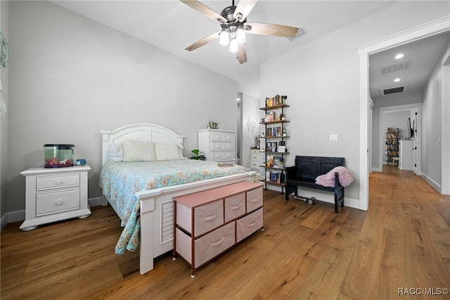 bedroom featuring light wood-style flooring, visible vents, and baseboards