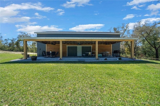 rear view of property featuring a lawn and a patio area