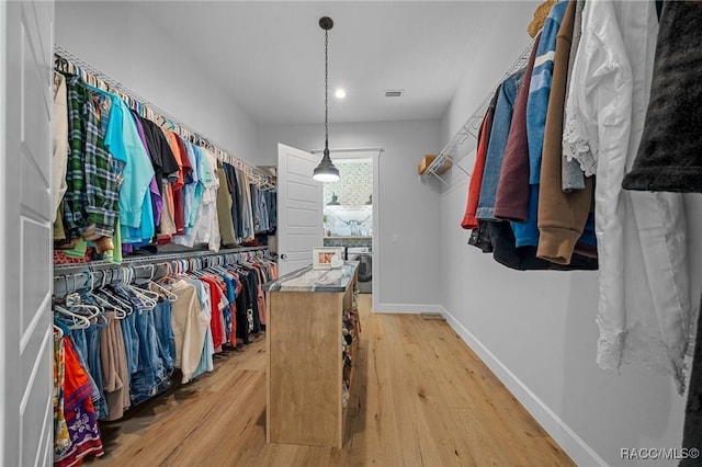 spacious closet with light wood-type flooring and visible vents