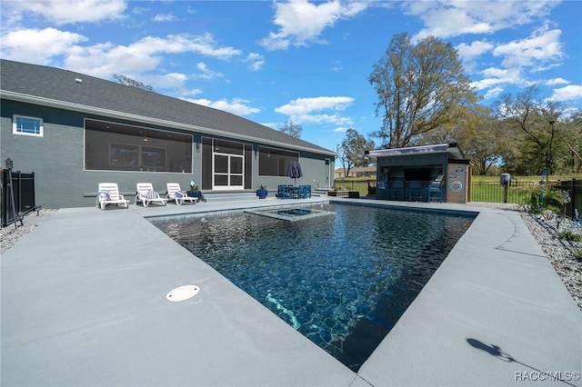 view of swimming pool with a patio area, fence, outdoor dry bar, and a fenced in pool