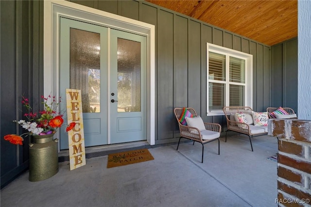 entrance to property featuring a porch, french doors, and board and batten siding