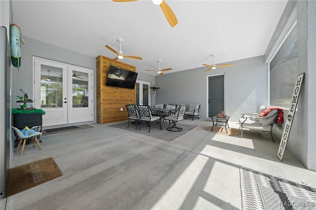 view of patio / terrace with outdoor dining space, a ceiling fan, and french doors