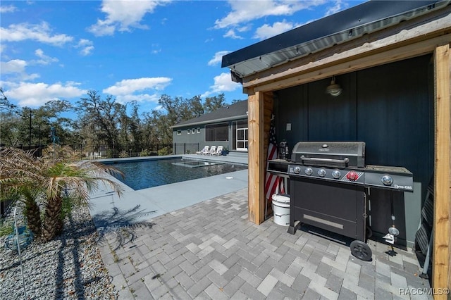 view of pool featuring a grill, fence, a fenced in pool, and a patio