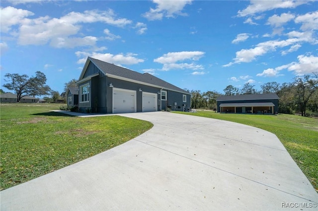 view of front of property with a garage, a front yard, concrete driveway, and board and batten siding