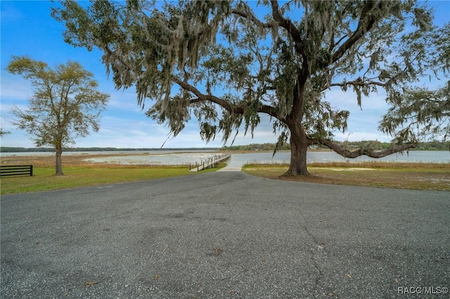 11707 SE 101st Court Rd, Belleview, FL 34420 - view of asphalt road featuring a water view