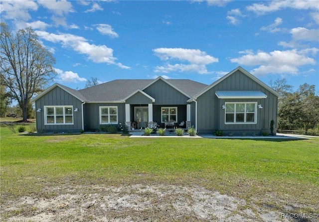 view of front of home featuring board and batten siding and a front yard