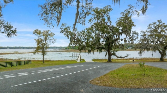 11707 SE 101st Court Rd, Belleview, FL 34420 - view of parking / parking lot featuring a water view