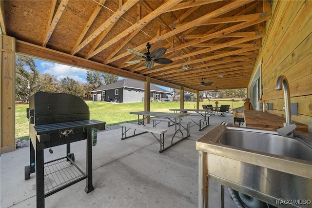 view of patio / terrace featuring ceiling fan, outdoor dining area, and a sink