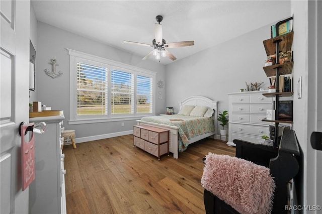 bedroom featuring ceiling fan, wood finished floors, and baseboards