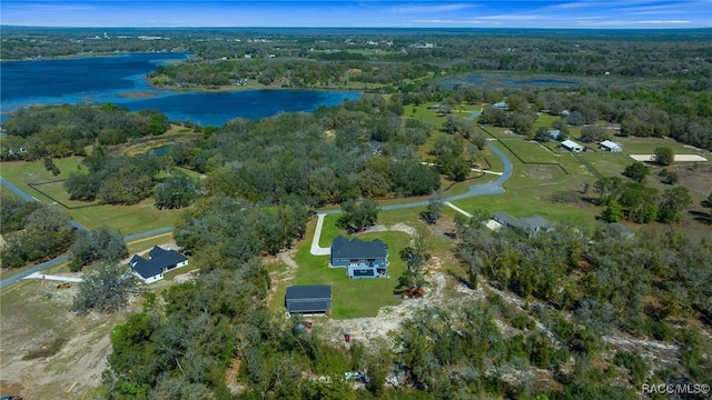 aerial view featuring a water view and a wooded view