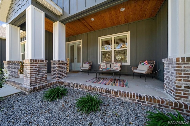 view of patio featuring a porch and french doors