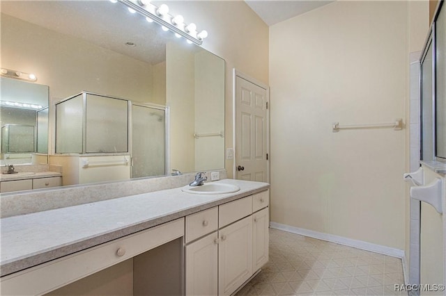 bathroom with vanity and a shower with shower door