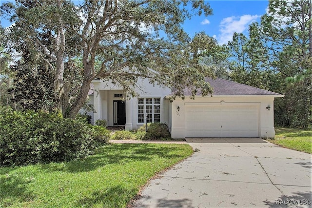 view of front of property with a front lawn and a garage