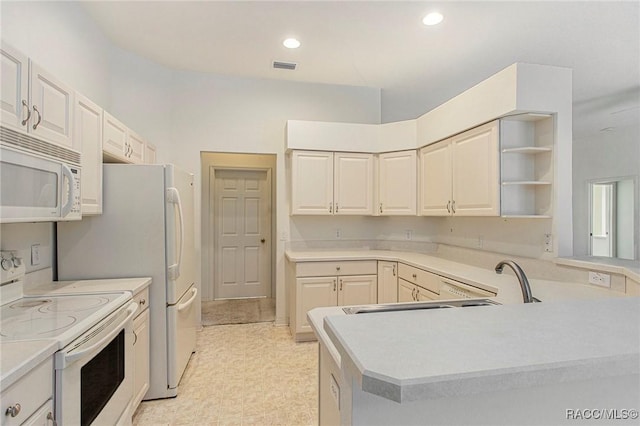 kitchen with kitchen peninsula and white appliances