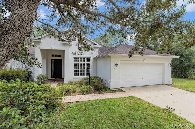 view of front of property featuring a front yard and a garage