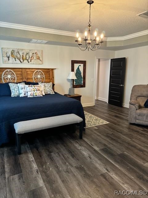 bedroom with a notable chandelier, dark hardwood / wood-style floors, and ornamental molding