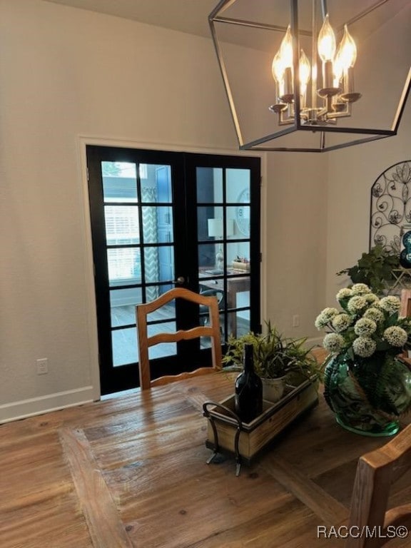 dining area featuring french doors and an inviting chandelier