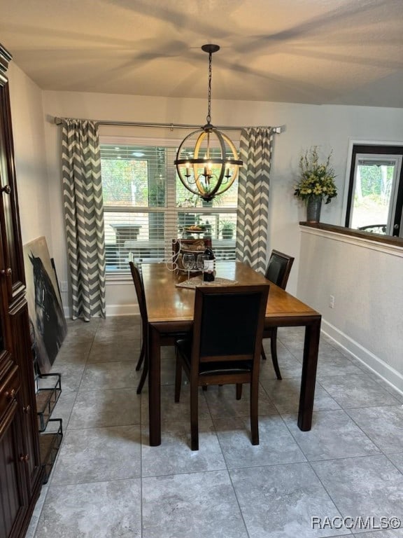 tiled dining room with plenty of natural light and a notable chandelier