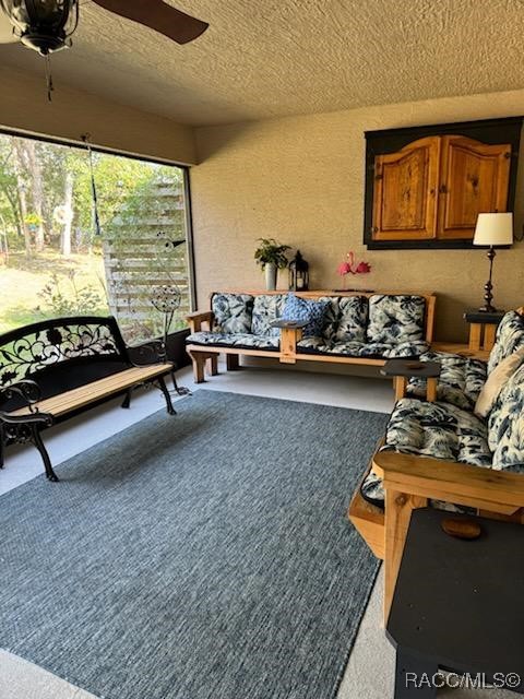 sunroom featuring ceiling fan