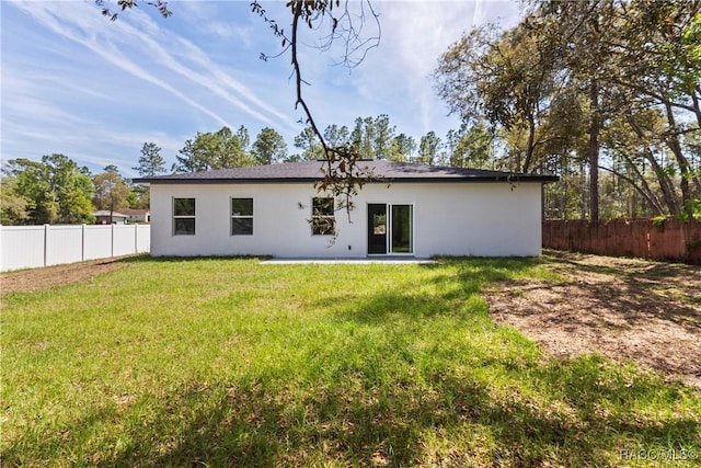 1413 W America Pl, Citrus Springs, FL 34434 - rear view of property featuring a fenced backyard, stucco siding, and a yard