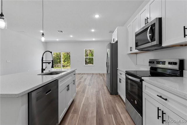 1413 W America Pl, Citrus Springs, FL 34434 - kitchen with a sink, appliances with stainless steel finishes, visible vents, light wood-type flooring, and recessed lighting