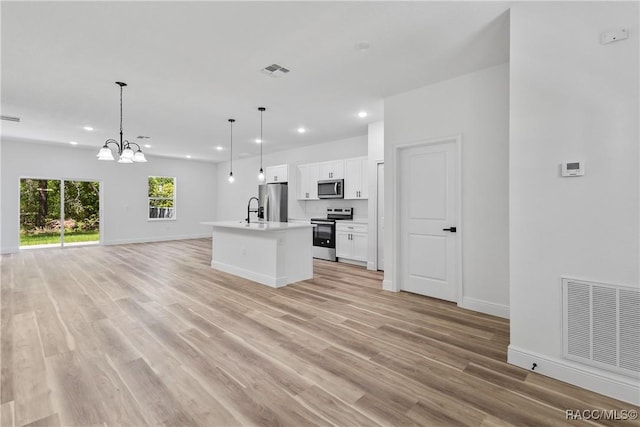 1413 W America Pl, Citrus Springs, FL 34434 - kitchen with visible vents, open floor plan, appliances with stainless steel finishes, and recessed lighting